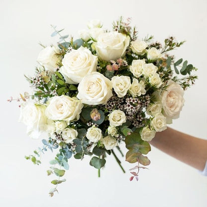 large headed white roses, spray roses and sesonal foliage