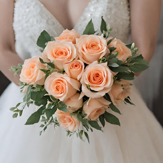 Peach roses hand tied into a bridal bouquet.